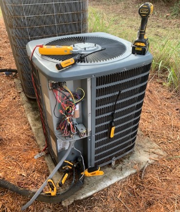HVAC Equipment Technician running diagnostic on a heat pump unit.